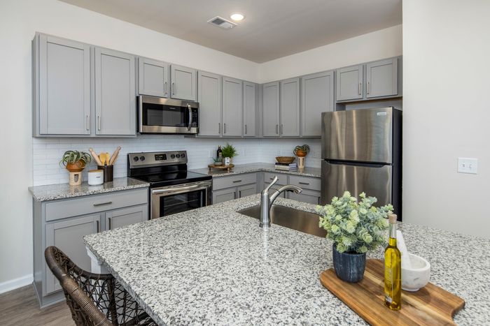 furnished kitchen area with island and appliances in single-family home
