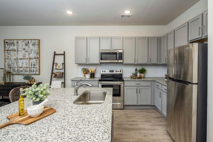 furnished kitchen area with island and appliances in single-family home