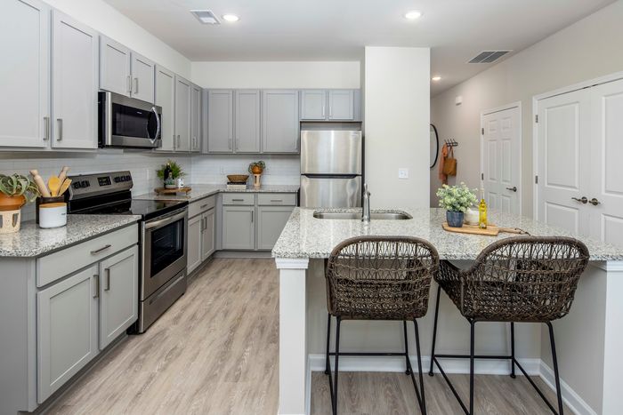 furnished kitchen area with island and appliances in single-family home