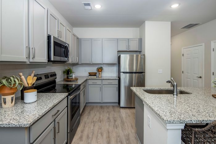 furnished kitchen area with island and appliances in single-family home