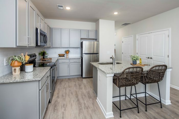 furnished kitchen area with island and appliances in single-family home