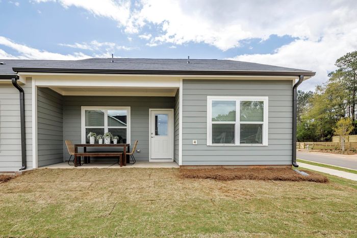 furnished patio area of backyard and exterior home on sunny day