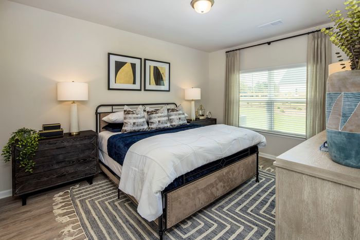 Three-Bedroom Homes in Loganville, GA - Covey Homes Loganville - Bedroom with Spacious Window, Double Nightstands, and Large Bed