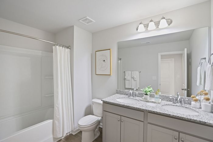 Furnished bathroom with double vanity and soaking tub