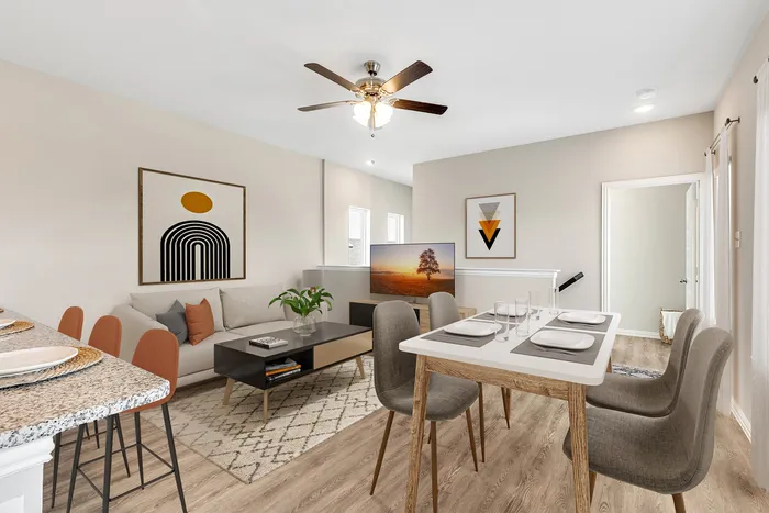 1-2 Bedroom Homes for rent in South Fort Worth, TX - Cottages at Summer Creek - a living and dining room with a couch, dining table, 4 chairs, a rug, and couches