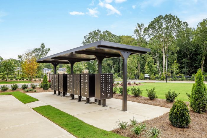 Accessible outdoor mailboxes with paved walkway and overhead shelter