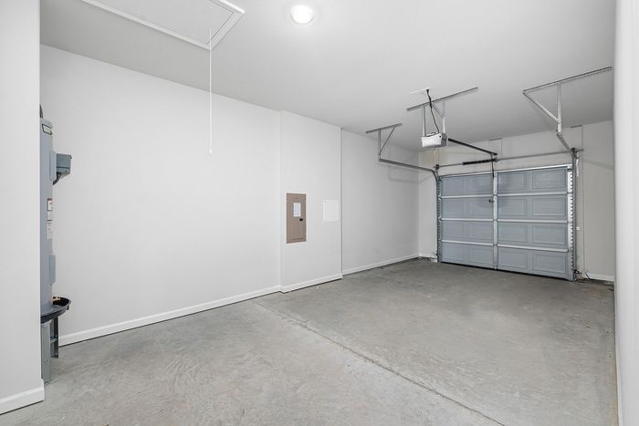 Bright, spacious garage with modern amenities and pristine white walls, perfect for storage or parking.