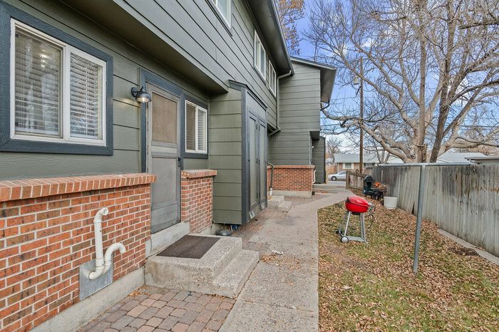 Inviting entrance with brick accents and private walkway leading to modern apartment.
