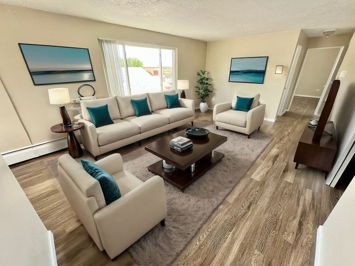 Bright and inviting living room with modern furnishings, elegant decor, and natural light streaming through large windows, creating a welcoming and tranquil space.