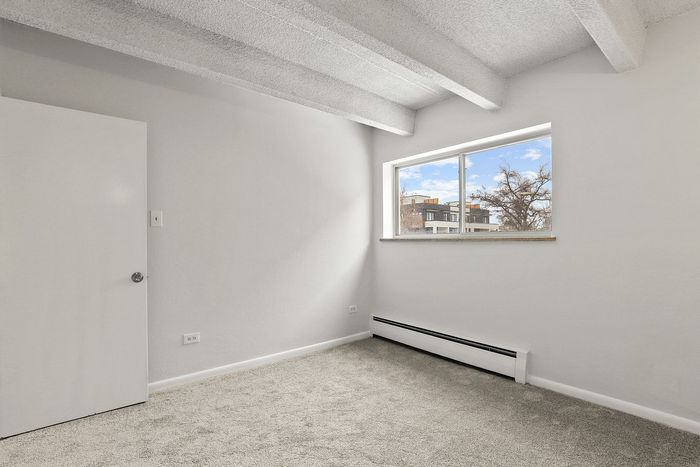 Bright and airy room with large window offering scenic outside views, perfect for peaceful living.