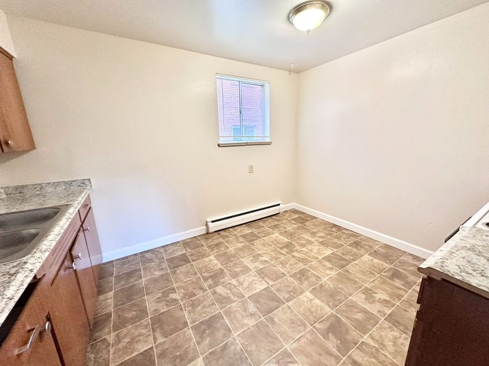 Bright and inviting kitchen with new granite countertops and tile flooring, perfect for cooking and entertaining.