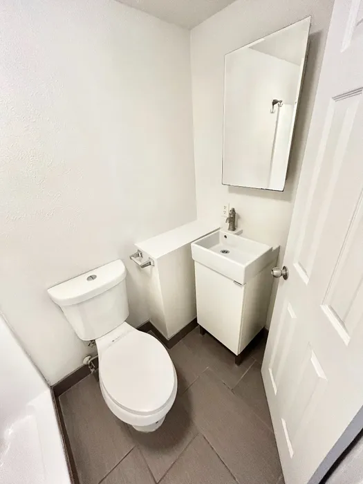 Contemporary bathroom with sleek fixtures, elegant sink, and modern tile flooring in a minimalistic design.