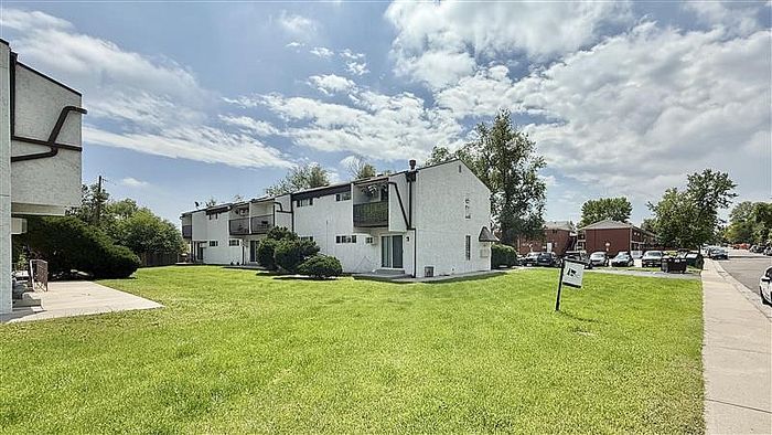 Charming apartment complex with modern architecture and lush green surroundings, perfect for comfortable living.