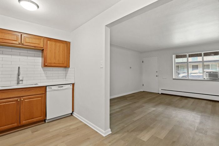 Bright, modern open-concept kitchen and living area with sleek wooden cabinetry and spacious light-filled interiors.