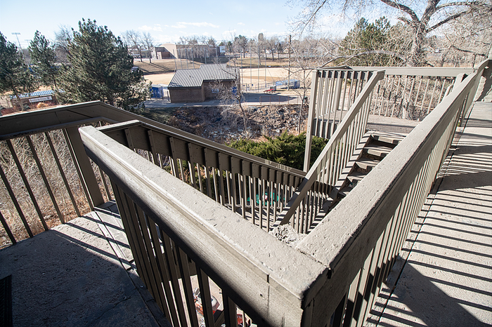 Inviting staircase with scenic views of lush park and sports fields, perfect for enjoying outdoor ambiance.