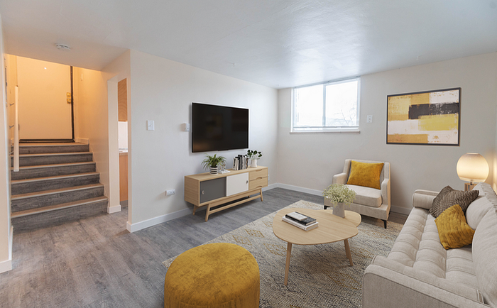 Chic modern living room featuring stylish furniture, bright window, and elegant decor in a welcoming setting.