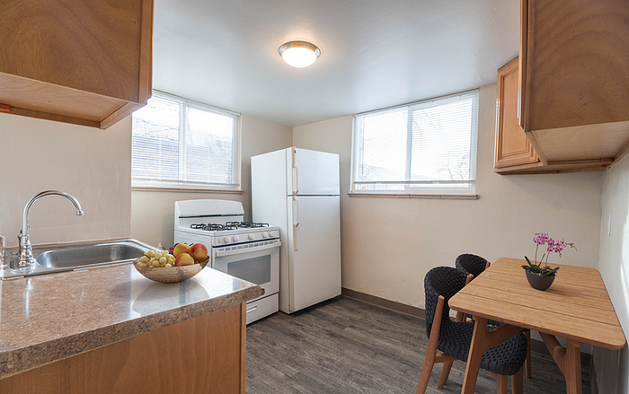 Bright and cozy kitchen with wooden cabinets, modern appliances, and a charming dining nook.
