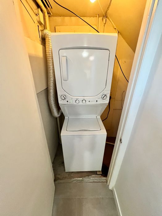 Efficient laundry nook featuring a sleek stackable washer and dryer unit.