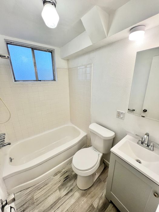Bright and modern bathroom featuring a sleek bathtub, stylish vanity, and contemporary fixtures.