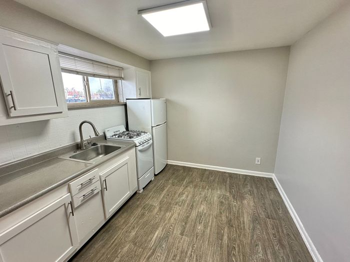 Bright and modern kitchen with sleek cabinetry, stainless steel sink, and contemporary appliances.
