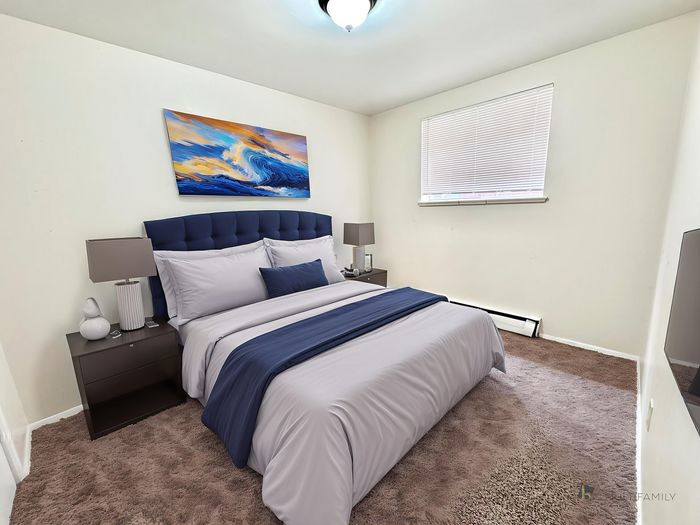 Elegant bedroom with plush bedding, modern decor, and soothing artwork, offering a serene retreat.