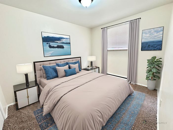 Inviting bedroom with a cozy bed, elegant decor, and natural light from a large window, perfect for relaxation and comfort.