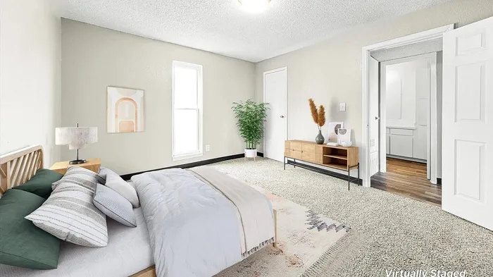 Bright and cozy bedroom with plush carpeting, modern furnishings, and a serene ambiance, showcasing virtual staging.