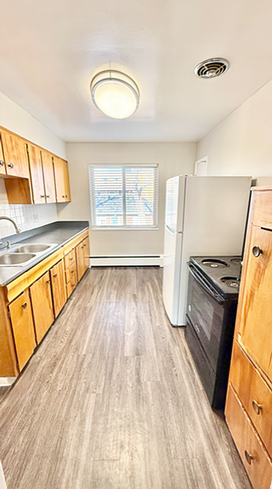 Bright and inviting kitchen with elegant wooden cabinets, modern appliances, and sleek flooring.