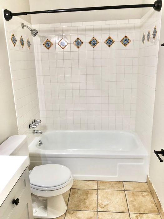 Elegant bathroom with decorative tiled shower and modern fixtures.