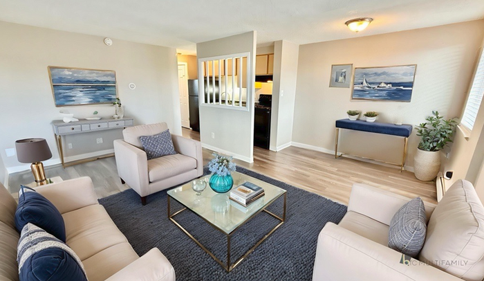 Charming living room with contemporary furnishings, soft neutral tones, and a cozy seating area, perfect for relaxation and comfort.