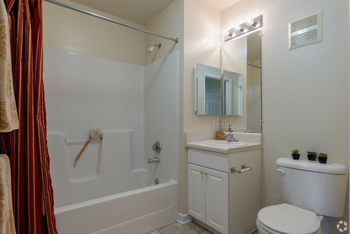 Chic bathroom with a modern bathtub, sleek vanity, and stylish lighting.