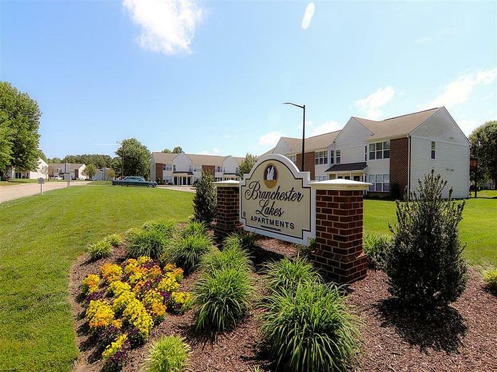 Entrance to Branchester Lakes Apartments with landscaped garden and welcoming sign.