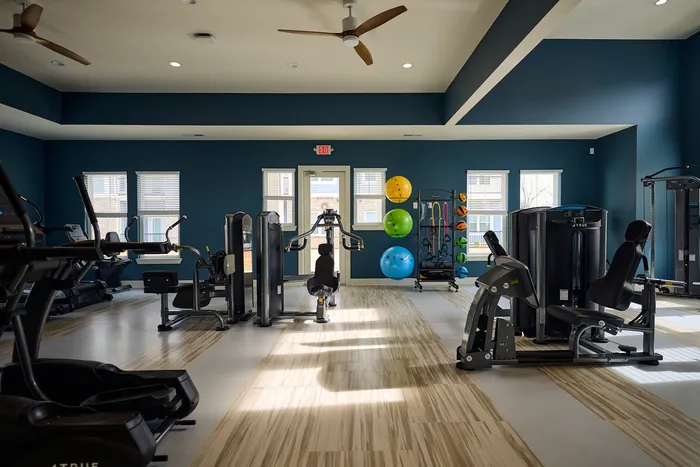 Bright, modern gym with state-of-the-art exercise equipment and stylish decor.