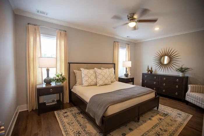 Elegant bedroom with a plush bed, stylish decor, and warm lighting creating a cozy atmosphere.