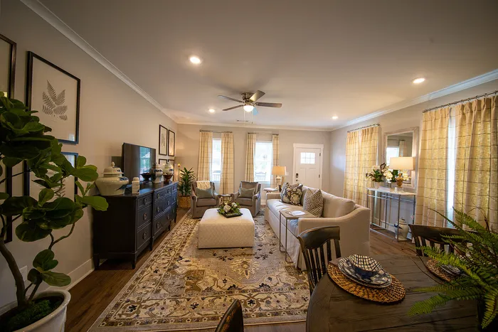 Inviting living room with elegant decor, featuring a plush sofa, stylish armchairs, and a chic dining area, perfect for relaxation and entertainment.