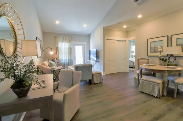 Inviting open-concept living room and dining area, featuring elegant decor, cozy seating, and warm natural lighting.