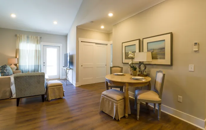 Elegant dining and living area with cozy seating, modern decor, and soft lighting, offering a warm and inviting atmosphere.