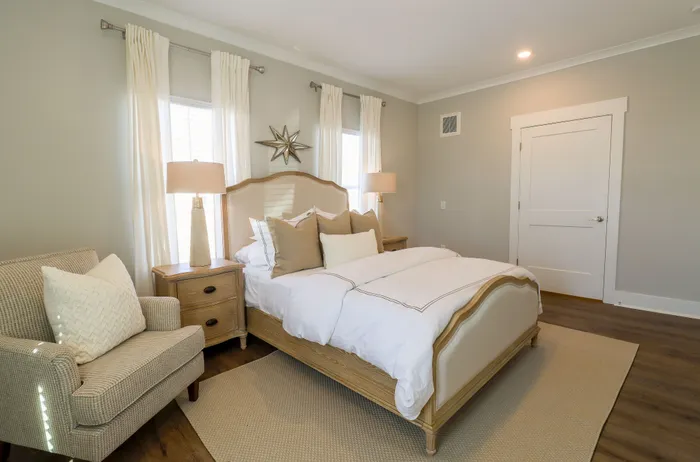 Inviting bedroom with elegant decor, featuring a plush bed, soft lighting, and serene natural tones.