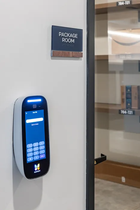 Modern package room entry with digital keypad access and secure shelving system.