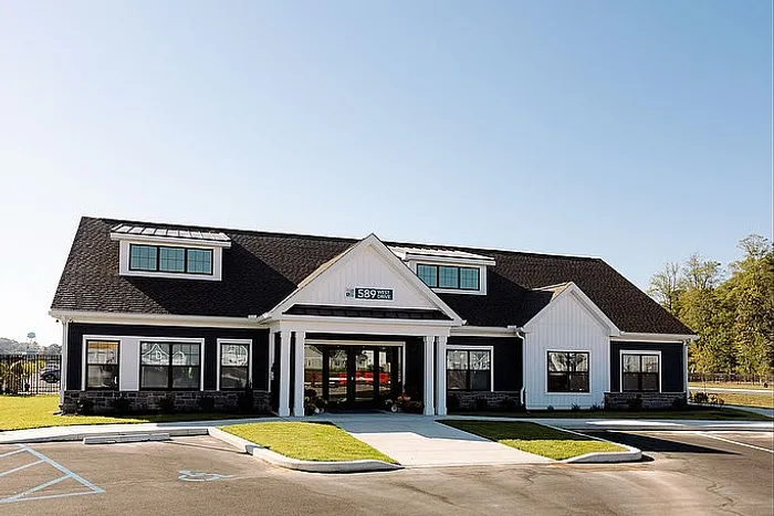 Charming community building with a modern design featuring a welcoming entrance and neatly landscaped surroundings.