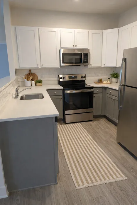 Modern kitchen design featuring sleek stainless steel appliances, elegant white cabinetry, and a chic subway tile backsplash.