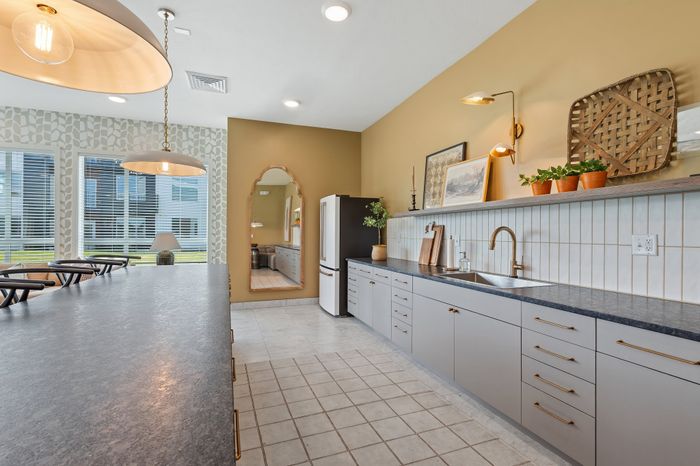 Luxurious kitchen with sleek countertops, warm lighting, and elegant decor, offering a modern and inviting ambiance.