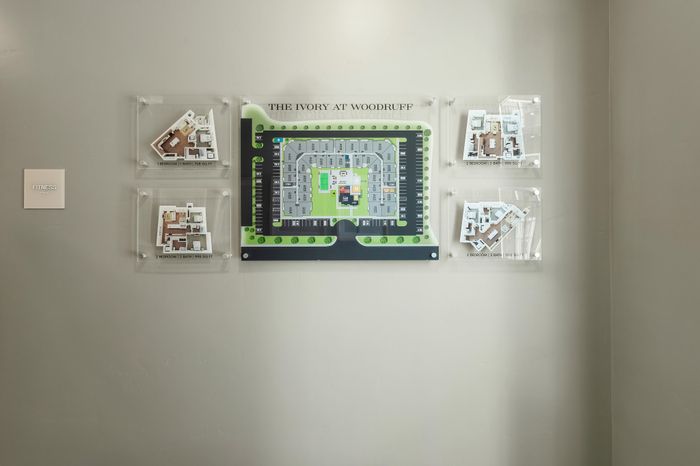 Interactive display showcasing The Ivory at Woodruff with detailed 3D floor plans of 1 and 2 bedroom units, including a comprehensive site map of the community layout.