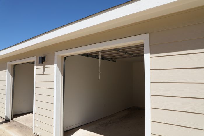 Spacious and clean light beige garage with open door in a sunny location, offering ample storage potential.
