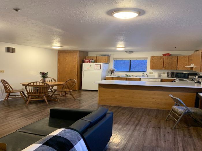 Inviting open-concept kitchen and dining area with warm wooden cabinetry and modern lighting.