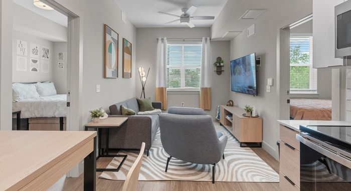 Contemporary apartment interior showcasing a cozy living room with chic decor, two inviting bedrooms, and ample natural light.