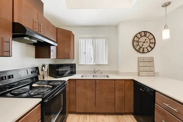 Modern kitchen with sleek wooden cabinetry, stainless steel appliances, and ambient lighting, perfect for culinary creativity.