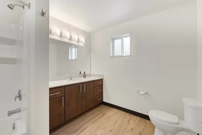 Bright and modern bathroom featuring sleek fixtures, elegant vanity, and natural lighting.