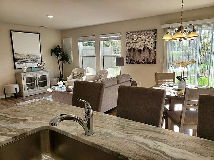 Bright and inviting living space showcasing modern furniture, large windows, and elegant decor, perfect for relaxation and entertainment.