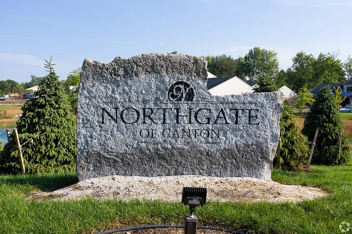Impressive stone sign for Northgate of Canton nestled in a lush green landscape, symbolizing a welcoming community.